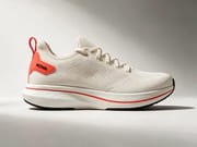 Ecommerce product photo of a running shoe on studio grey