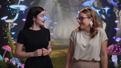 Two friends laughing through a glowing forest