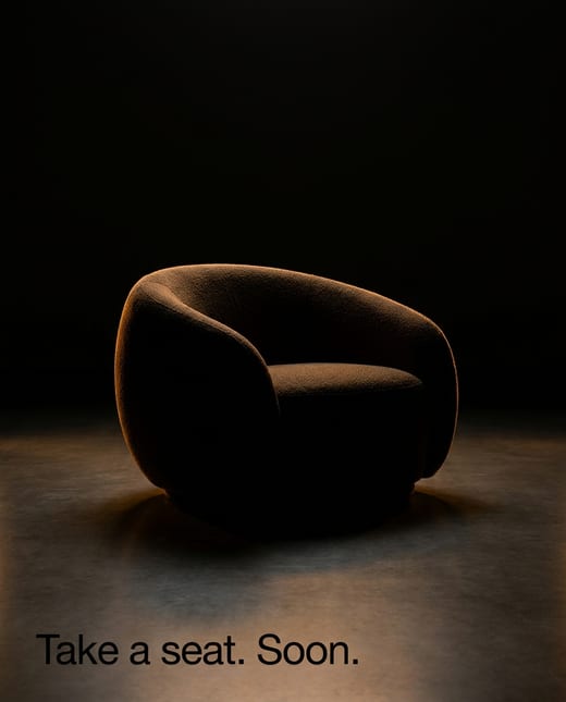 Teaser ad: a chair silhouette traced by amber light