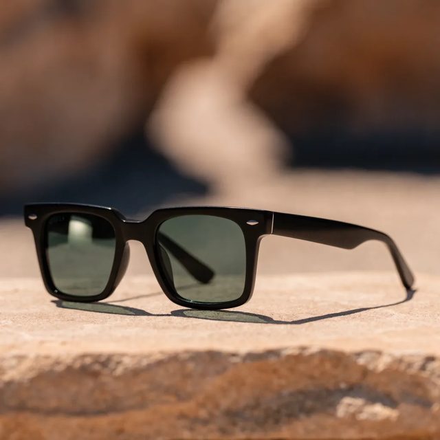 Sunglasses on warm stone
