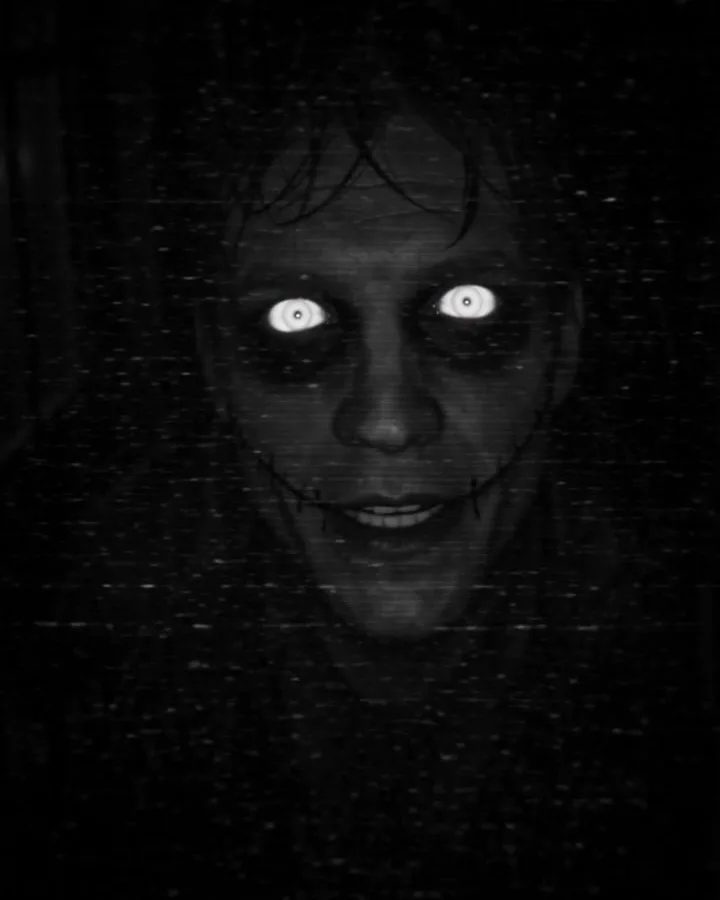 Night-vision doorbell footage of a pale face with glowing eyes pressed to the lens