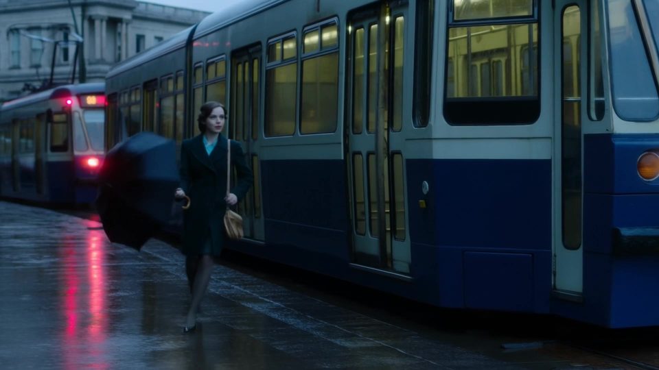 Off the tram, umbrella up